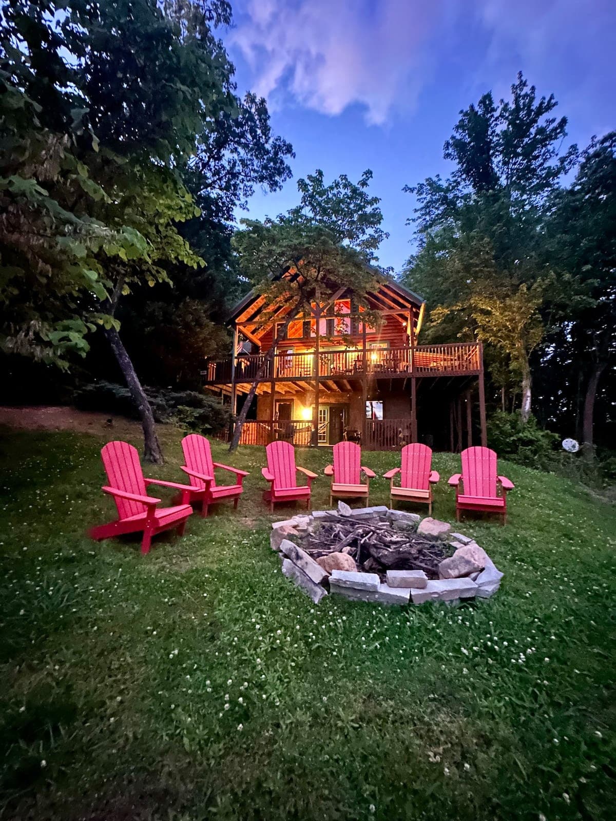 Thistle Britches cabin glowing warmly among the trees at night