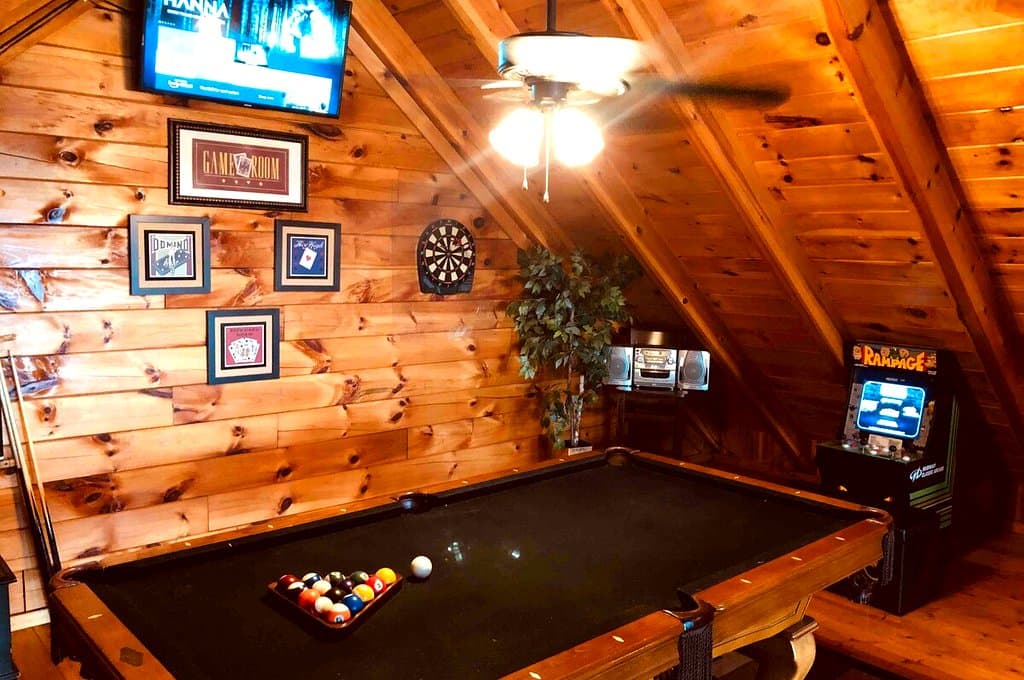 Pool table beneath the wood ceiling in the cabin game room