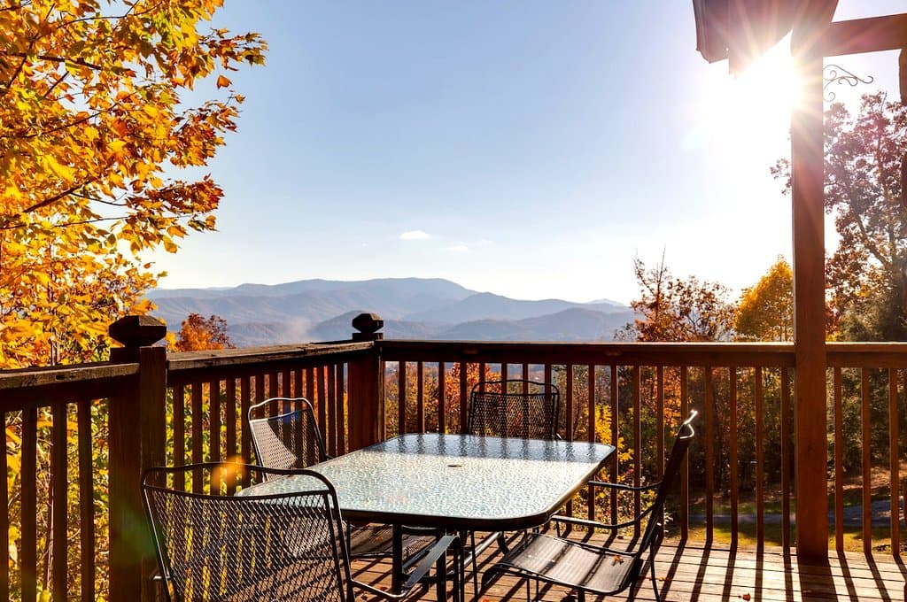 Round outdoor table on the deck with autumn mountain views