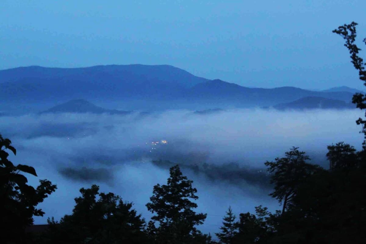 Morning mist settling across the mountain ridges below Thistle Britches