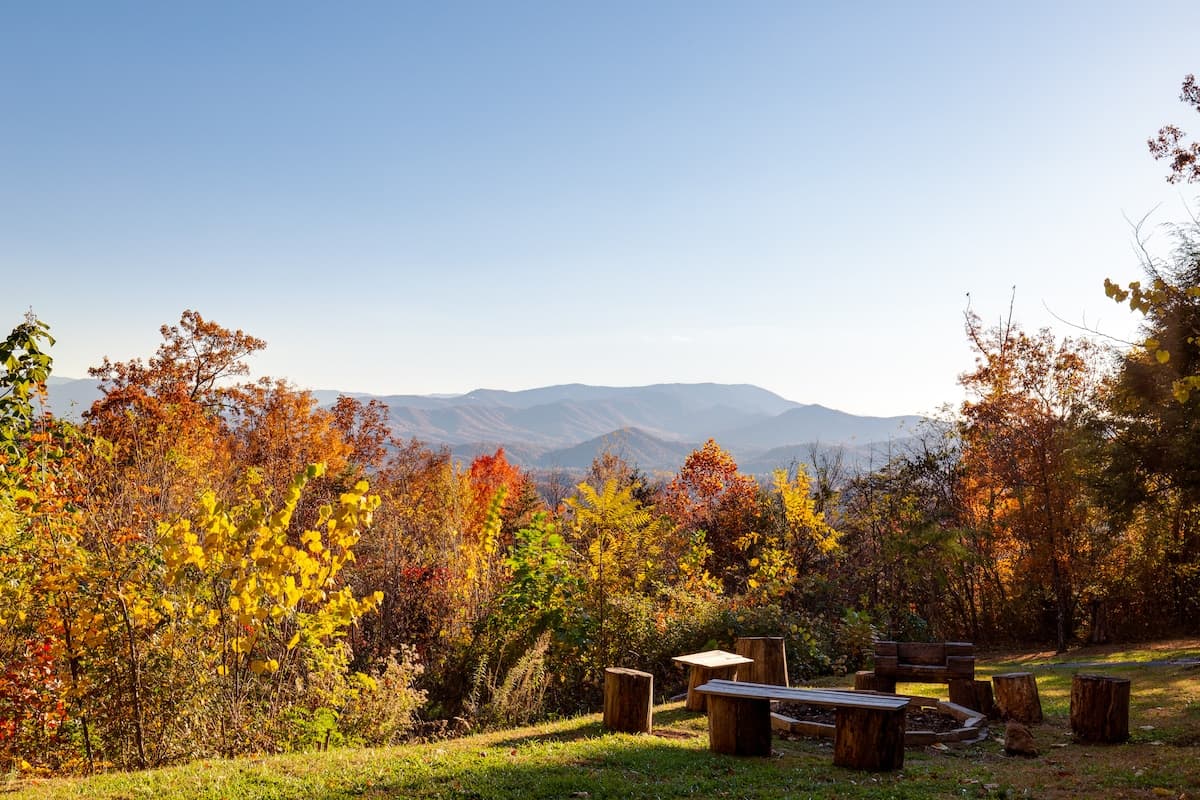 Fire pit area overlooking the Smoky Mountain valley surrounded by vibrant fall foliage