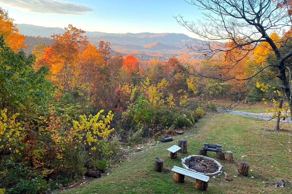 Actual photo from Thistle Britches: Stone fire pit in the cabin yard with autumn mountains beyond